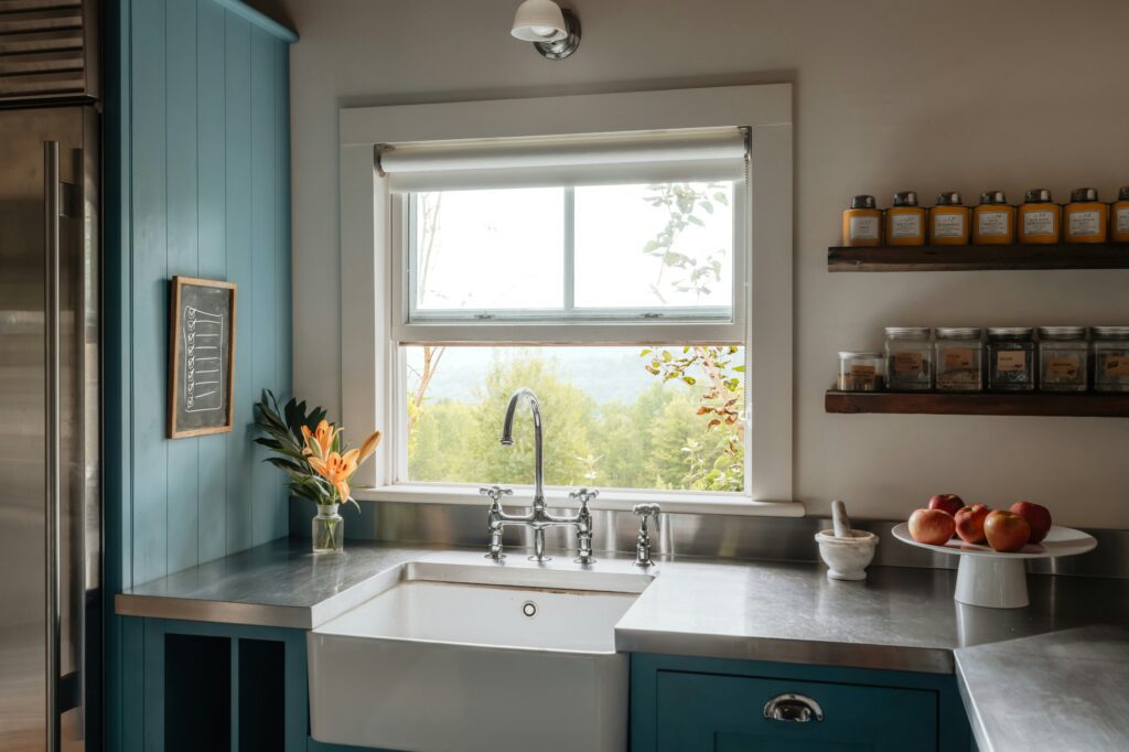 farmhouse sink blue cabinets open shelves