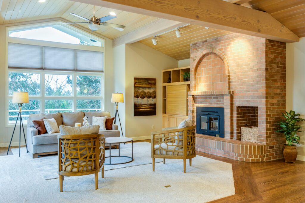 vaulted living room big windows beam fireplace